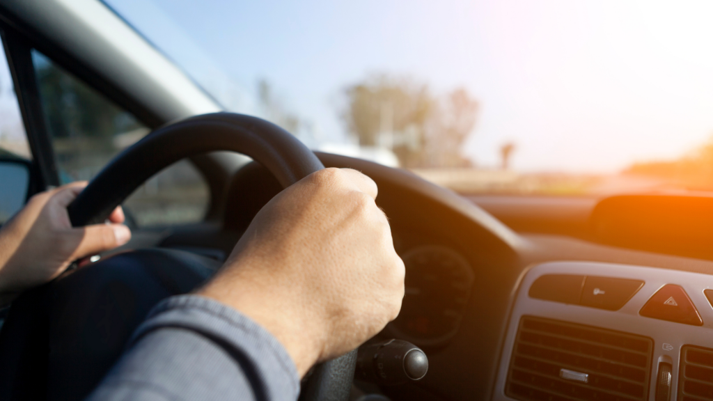 driver behind a wheel of a car